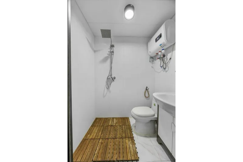  Yacht Photos Pics Modern bathroom with shower, toilet, wooden floor, and water heater, Gospel 39, 2024 model.