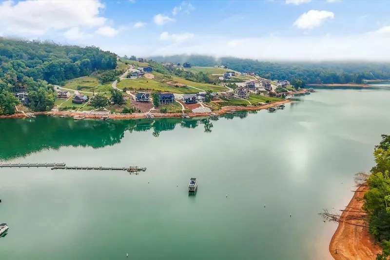  Yacht Photos Pics Aerial view of serene lake with surrounding homes and lush greenery, Gospel 39, 2024.