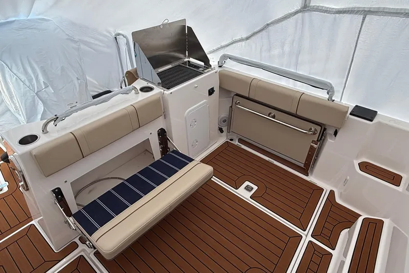  Yacht Photos Pics 2025 Ranger Tugs R-25 boat interior with seating and grill on teak deck.