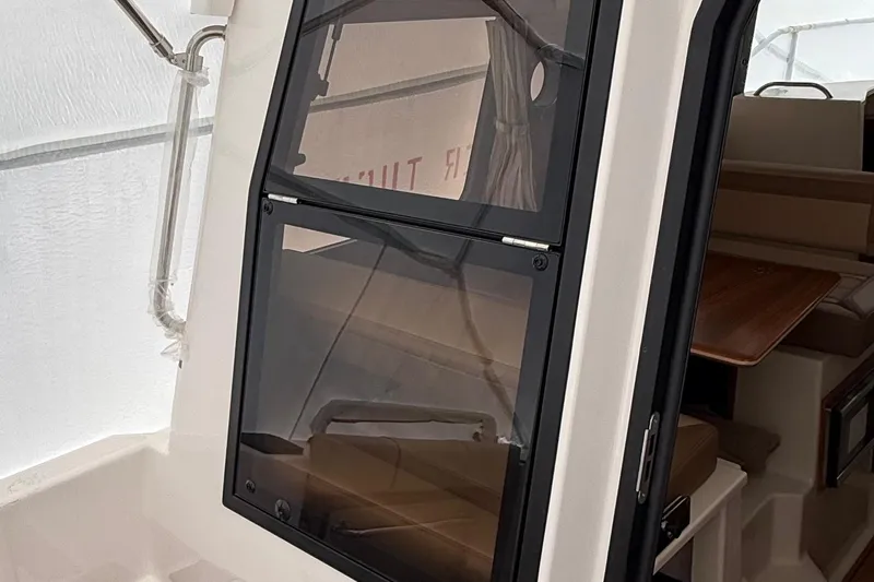  Yacht Photos Pics 2025 Ranger Tugs R-25 cabin interior with window and seating area.