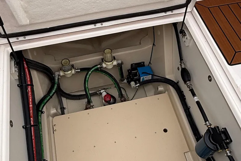  Yacht Photos Pics Engine compartment of 2025 Ranger Tugs R-25 boat, showcasing hoses and components.