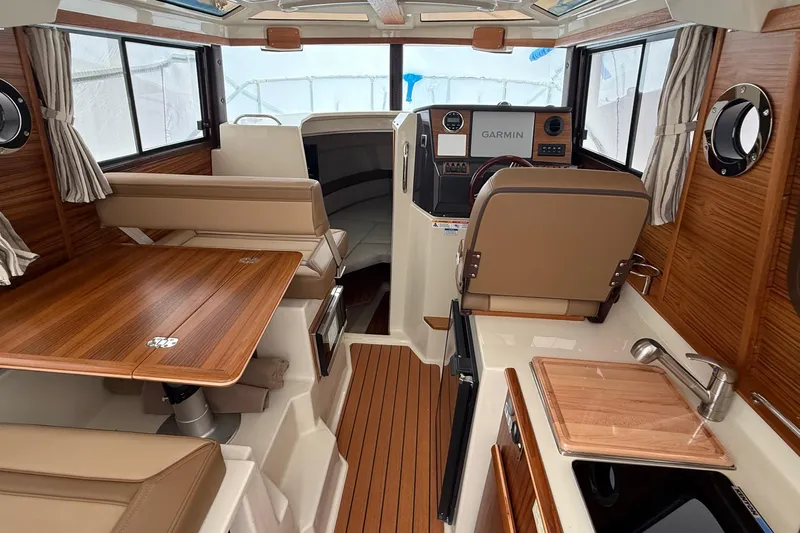  Yacht Photos Pics Interior of 2025 Ranger Tugs R-25 boat with wood accents and modern amenities.