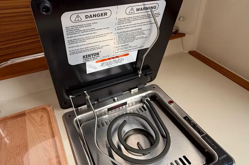  Yacht Photos Pics Electric stove in 2025 Ranger Tugs R-25 boat galley with safety warnings displayed.