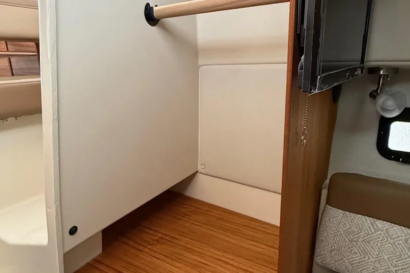  Yacht Photos Pics Interior of 2025 Ranger Tugs R-25, featuring a compact storage area and wooden flooring.