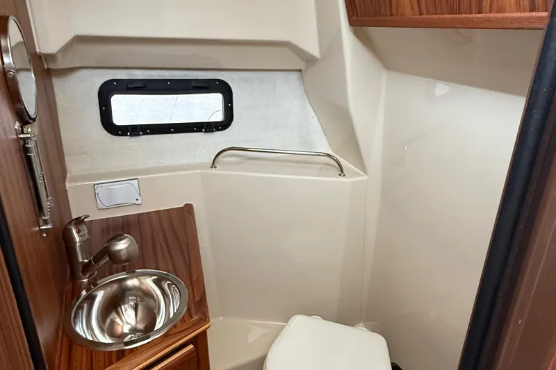  Yacht Photos Pics 2025 Ranger Tugs R-25 boat bathroom with sink, toilet, and window.
