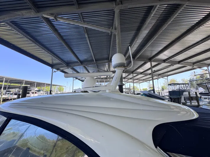 Skeeter Yacht Photos Pics 2004 Sea Ray 420 Sundancer yacht under covered dock, showcasing sleek design and radar equipment.