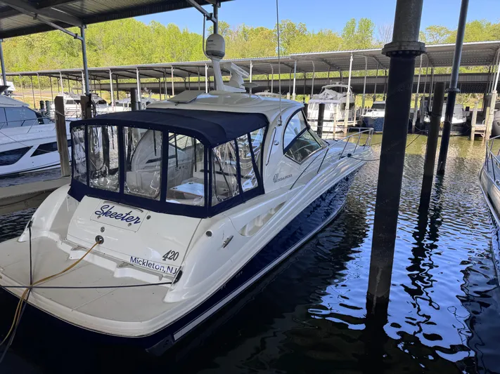 Skeeter Yacht Photos Pics 2004 Sea Ray 420 Sundancer docked in a marina, featuring a sleek design and covered cockpit.