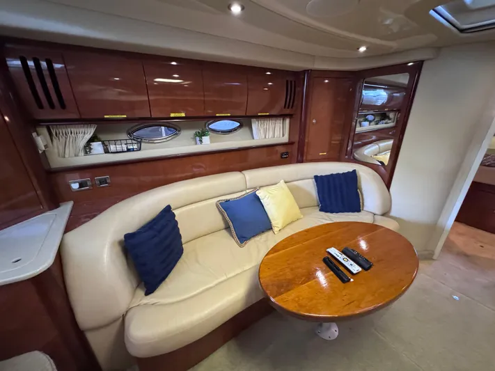 Skeeter Yacht Photos Pics Luxurious interior of 2004 Sea Ray 420 Sundancer yacht with plush seating and wooden table.