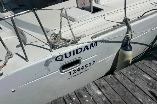 Quidam Yacht Photos Pics Lagoon 440 catamaran from 2004 docked, displaying the name "Quidam" and registration number.