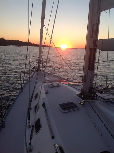 Sail N By Yacht Photos Pics Sailing on a 2001 Catalina 400 MkII at sunset, serene ocean view.