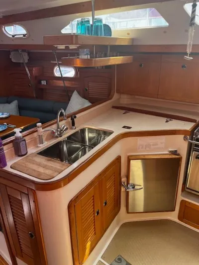 Sail N By Yacht Photos Pics Interior of 2001 Catalina 400 MkII sailboat with wooden cabinetry and modern kitchen amenities.