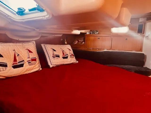 Sail N By Yacht Photos Pics Cozy cabin interior of 2001 Catalina 400 MkII with red bedding and nautical-themed pillows.
