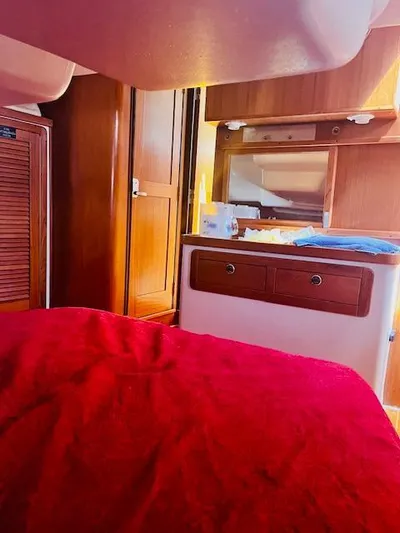Sail N By Yacht Photos Pics Interior of 2001 Catalina 400 MkII sailboat with wooden cabinetry and red bedding.