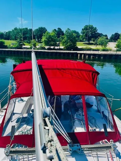Sail N By Yacht Photos Pics Catalina 400 MkII sailboat with red canopy docked by lush green park, 2001 model.