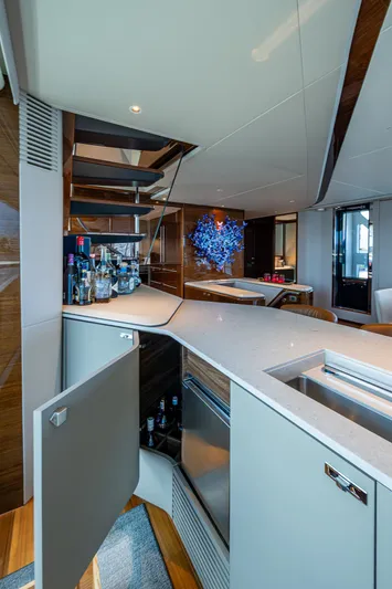  Yacht Photos Pics Luxurious interior of 2022 Princess X95 yacht with modern kitchen and bar area.