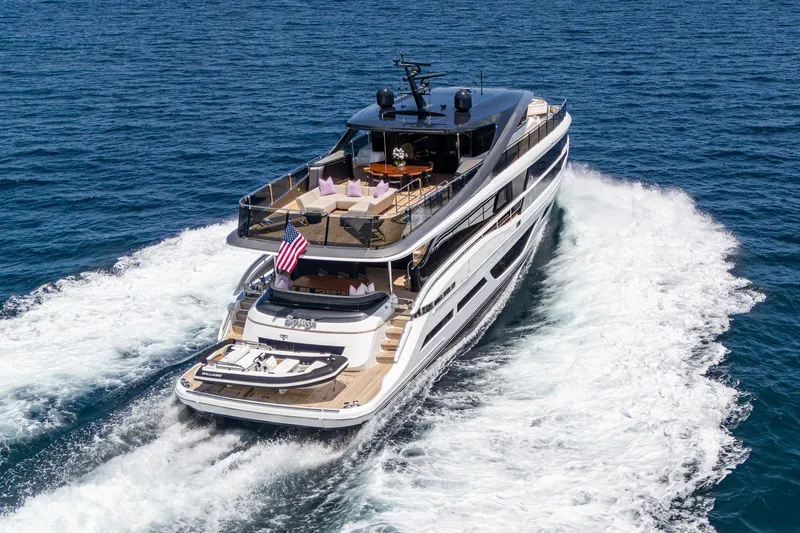  Yacht Photos Pics Luxurious 2022 Princess X95 yacht cruising on open sea, showcasing elegant design and spacious decks.