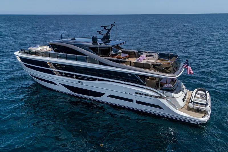  Yacht Photos Pics Luxurious 2022 Princess X95 yacht cruising on open sea, featuring sleek design and spacious decks.