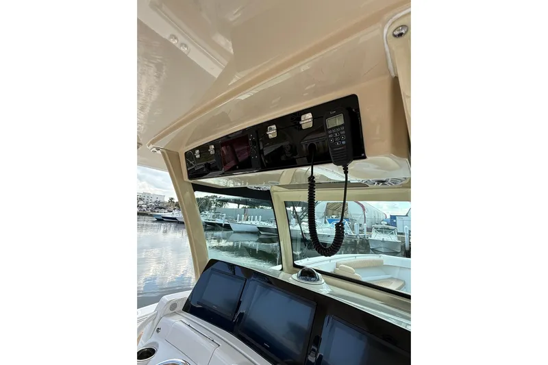 Sprinkles Yacht Photos Pics 2024 HCB 39 Speciale boat interior with navigation equipment and waterfront view.