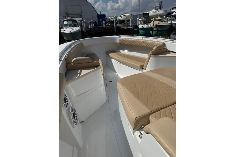 Sprinkles Yacht Photos Pics 2024 HCB 39 Speciale boat interior with tan seating and speakers at a marina.