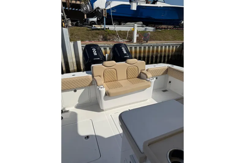 Sprinkles Yacht Photos Pics 2024 HCB 39 Speciale boat interior with beige seating and twin outboard engines.
