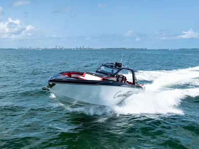  Yacht Photos Pics 2025 Cigarette 42 Auroris speedboat cruising on open water under clear blue skies.