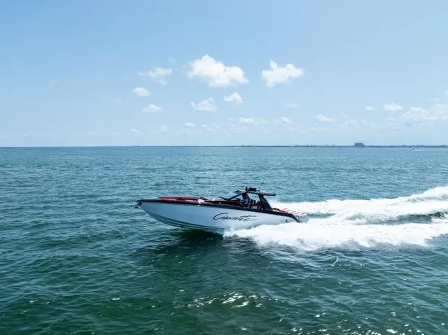  Yacht Photos Pics 2025 Cigarette 42 Auroris speedboat cruising on open water under clear blue sky.