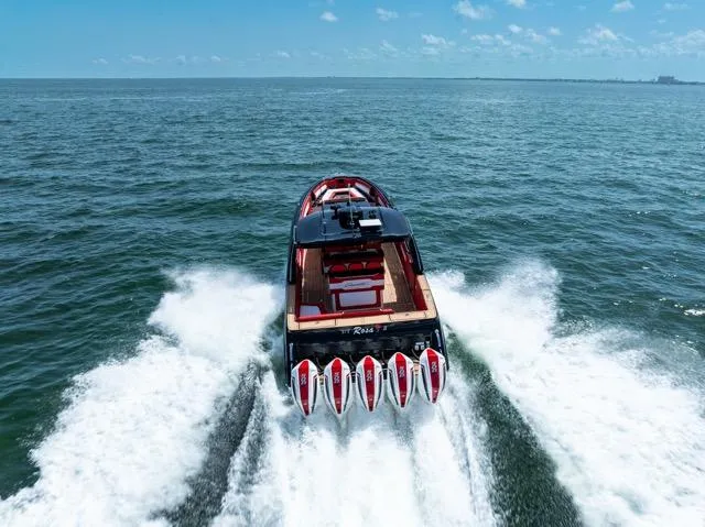  Yacht Photos Pics 2025 Cigarette 42 Auroris speedboat cruising on open water, rear view.