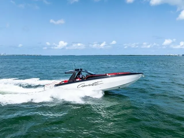  Yacht Photos Pics 2025 Cigarette 42 Auroris speedboat cruising on open water under a clear blue sky.