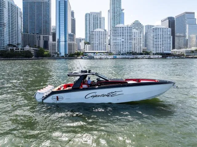  Yacht Photos Pics 2025 Cigarette 42 Auroris boat cruising near city skyline, modern architecture in background.
