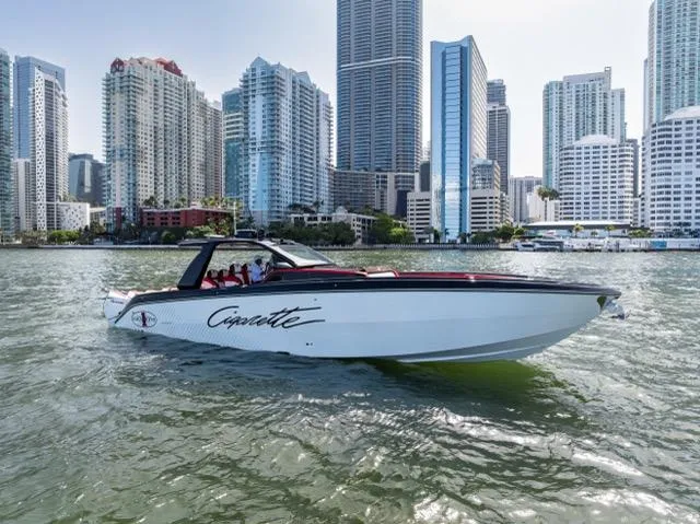  Yacht Photos Pics 2025 Cigarette 42 Auroris boat cruising near city skyline.