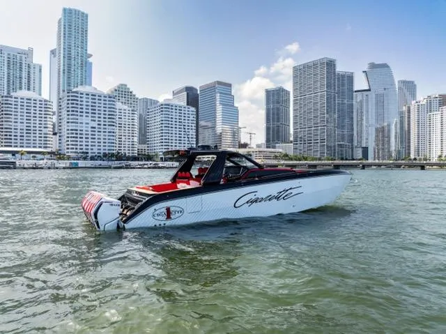  Yacht Photos Pics 2025 Cigarette 42 Auroris boat cruising near city skyline.