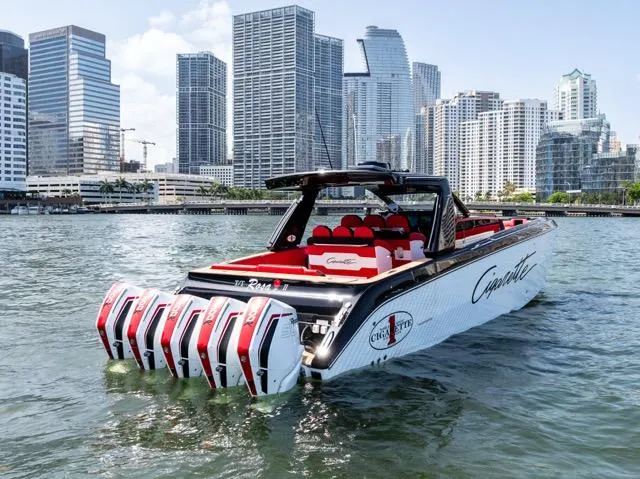  Yacht Photos Pics 2025 Cigarette 42 Auroris boat with multiple engines, cruising near a city skyline.