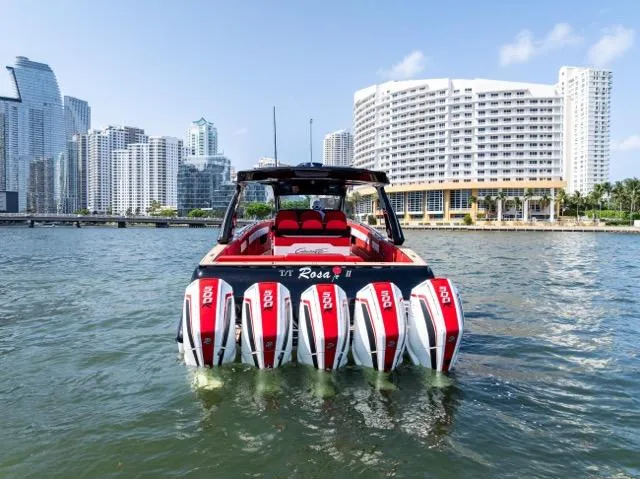  Yacht Photos Pics 2025 Cigarette 42 Auroris boat with multiple engines, city skyline in background.