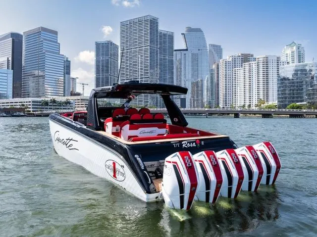  Yacht Photos Pics 2025 Cigarette 42 Auroris boat with multiple engines, city skyline in background.