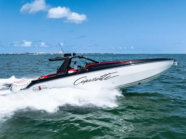 Yacht Photos Pics 2025 Cigarette 42 Auroris speedboat cruising on open water under clear blue skies.