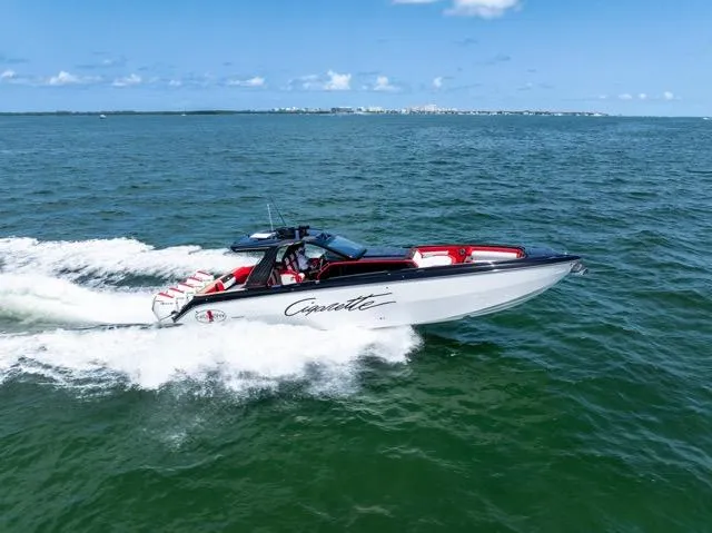  Yacht Photos Pics 2025 Cigarette 42 Auroris speedboat cruising on open water under a clear blue sky.