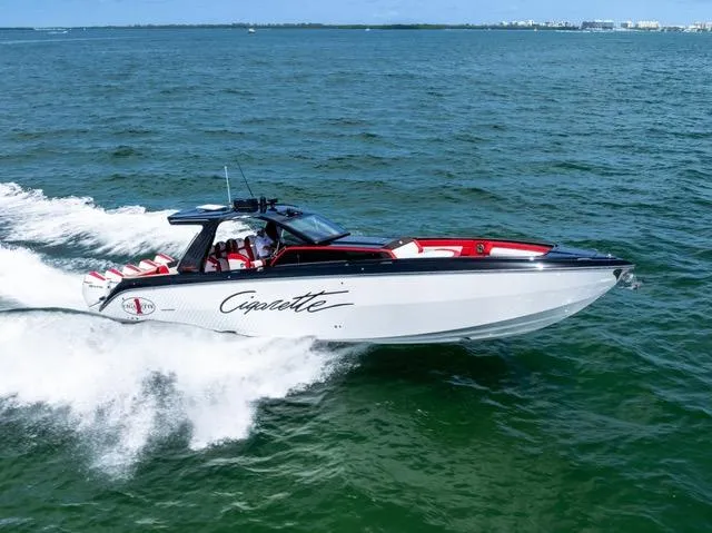  Yacht Photos Pics 2025 Cigarette 42 Auroris speedboat cruising on open water.