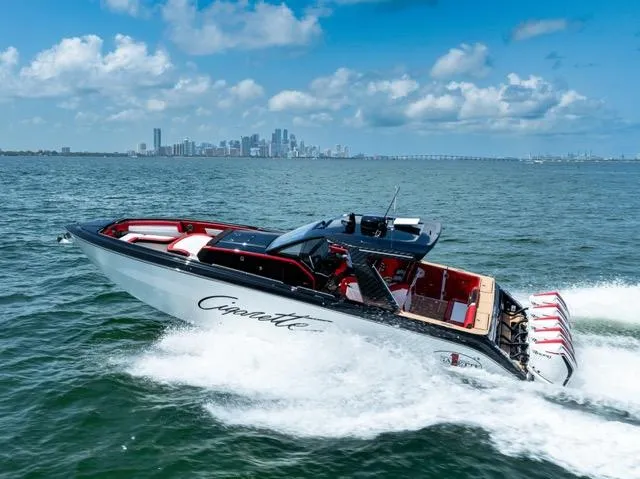  Yacht Photos Pics 2025 Cigarette 42 Auroris speedboat cruising on open water with city skyline in background.