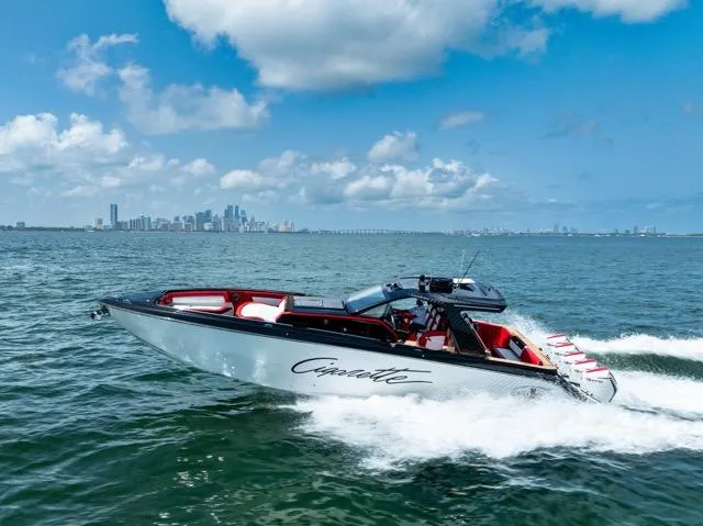  Yacht Photos Pics 2025 Cigarette 42 Auroris speedboat cruising on open water under a clear blue sky.