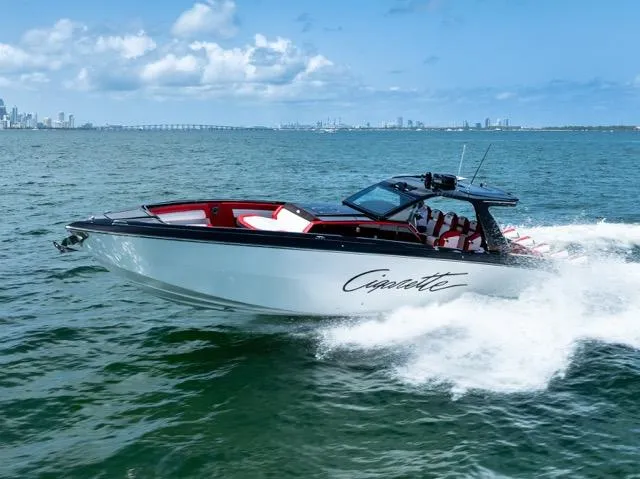  Yacht Photos Pics 2025 Cigarette 42 Auroris speedboat cruising on open water, showcasing sleek design and performance.