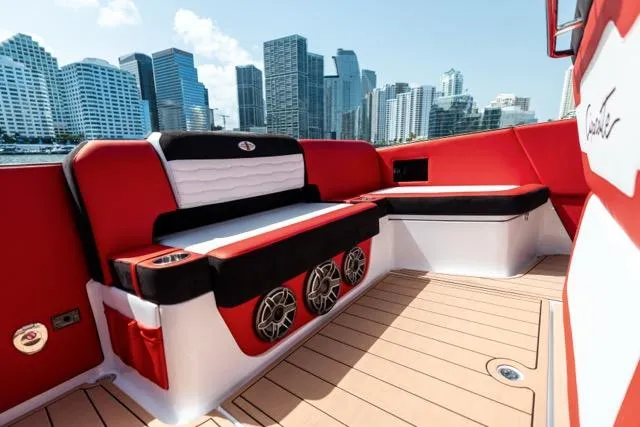  Yacht Photos Pics 2025 Cigarette 42 Auroris boat interior with red and black seating, city skyline in background.