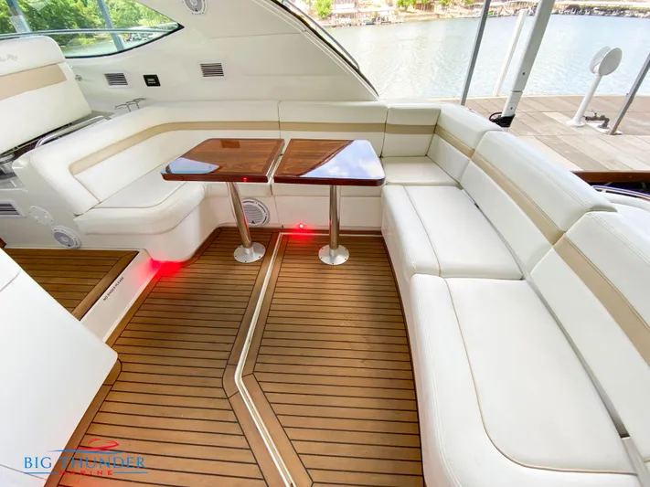  Yacht Photos Pics Luxurious 2010 Sea Ray 470 Sundancer yacht interior with white leather seating and wooden tables.
