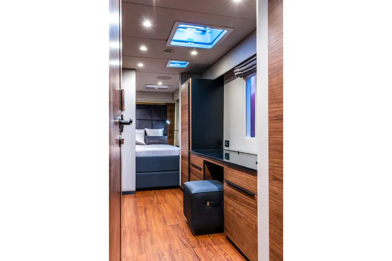 Surf Soul Yacht Photos Pics Luxurious interior of 2023 Sunreef 50 yacht with modern wood finishes and cozy bedroom.