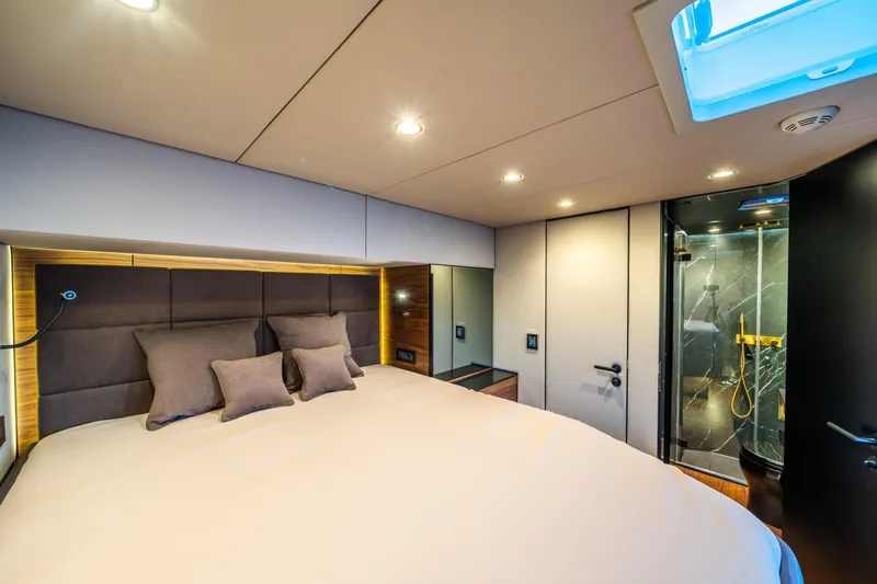 Surf Soul Yacht Photos Pics Luxurious bedroom interior of 2023 Sunreef 50 yacht with modern ensuite bathroom.