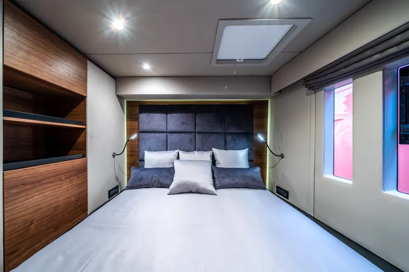 Surf Soul Yacht Photos Pics Luxurious bedroom interior of 2023 Sunreef 50 yacht with modern design and ambient lighting.