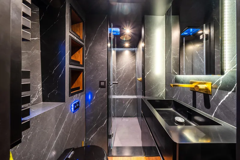 Surf Soul Yacht Photos Pics Luxurious bathroom in 2023 Sunreef 50 yacht with sleek black marble and gold accents.