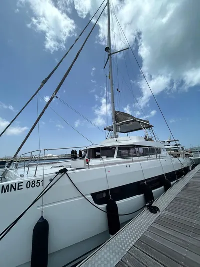 Voyager Yacht Photos Pics 2023 Bali 5.4 catamaran docked under a partly cloudy sky.