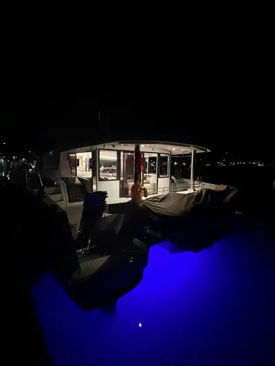 Voyager Yacht Photos Pics Night view of a 2023 Bali 5.4 yacht with illuminated deck and interior.