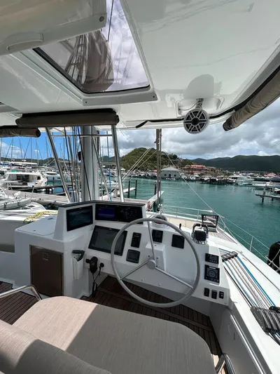 Voyager Yacht Photos Pics Helm of 2023 Bali 5.4 yacht in marina, featuring modern navigation equipment and scenic harbor view.
