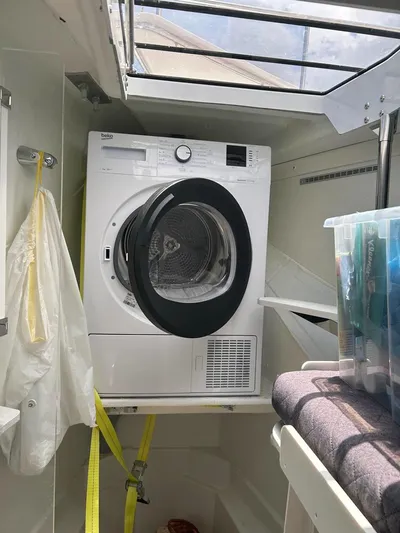 Voyager Yacht Photos Pics Washing machine inside a Bali 5.4 boat, 2023 model, with open hatch above.